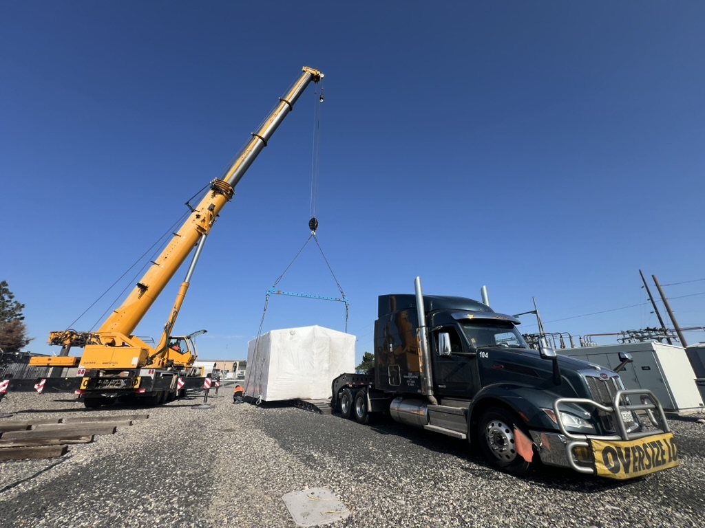 Oversized Generator being crane loaded onto an open deck truck